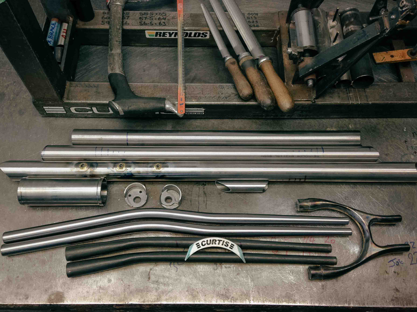 Steel tubes laid out on the Curtis workshop bench